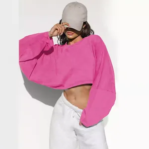 Bright pink women's cropped crewneck sweatshirt featuring casual loose long sleeves