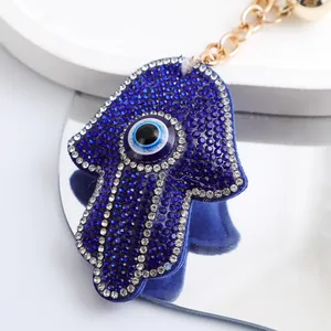 Gros plan détaillé du porte-clés Main de Fatma en strass bleus avec le motif Mauvais Œil.