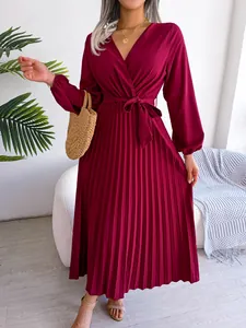 Close-up detail of the burgundy wrap V-neckline and elegant pleated skirt texture