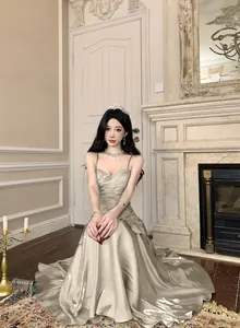Elegant metallic mermaid evening gown with spaghetti straps and delicate pleated detail