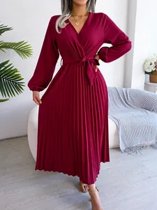 Elegant burgundy long-sleeve pleated maxi dress featuring a V-neck and stylish waist tie.