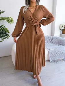 Detailed view of an elegant brown V-neck pleated maxi dress featuring a matching tie belt