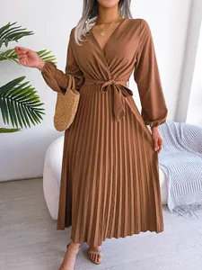 Detailed view of brown long sleeve pleated maxi dress with V-neckline and waist tie