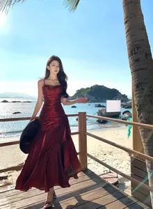 Elegant mermaid red ruffled evening dress with spaghetti straps in beach setting