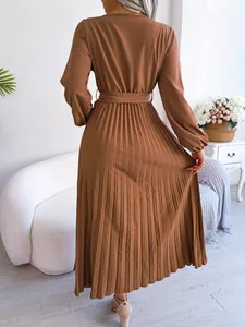 Elegant back view of brown pleated maxi dress featuring long sleeves and matching waist belt