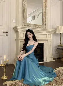 Elegant mermaid shimmer blue evening gown with shimmering metallic fabric and strapless design.