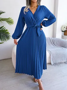 Detailed view of an elegant blue V-neck pleated maxi dress with long sleeves.