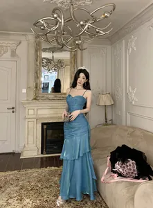 Elegant blue mermaid ruffle evening dress with spaghetti straps in luxury setting