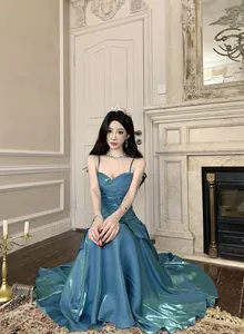 Elegant teal shimmer mermaid evening dress with ruffled hem and spaghetti straps