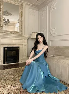 Elegant blue mermaid shiny evening gown for banquet shown in luxury room setting