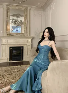 Detailed view of iridescent blue mermaid dress with ruffles in a classical setting