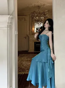 Elegant teal mermaid ruffle evening gown with spaghetti straps shown on model