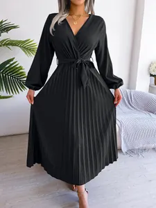 Elegant black long-sleeved pleated maxi dress featuring a V-neck and stylish waist tie belt.
