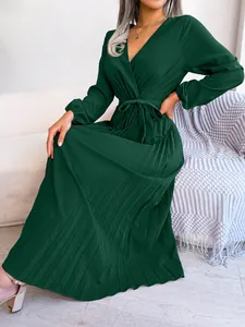 Elegant dark green V-neck pleated maxi dress with long sleeves and waist tie detail.