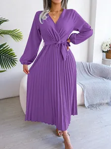 Detail view of purple pleated maxi dress featuring a cross V-neck and long sleeves.