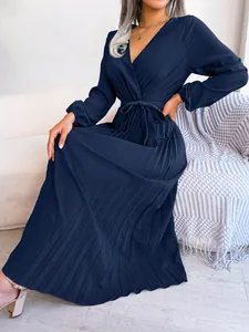 A detailed view showing the pleated texture of an elegant navy blue V-neck maxi dress.