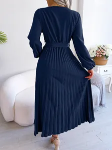 Back view of navy blue long sleeve pleated maxi dress showing detailed pleated fabric texture