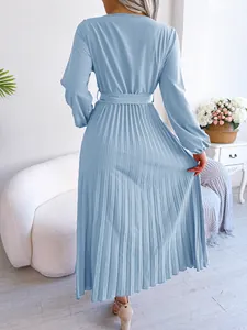 Back view of a light blue long-sleeved pleated maxi dress with flowy pleated details