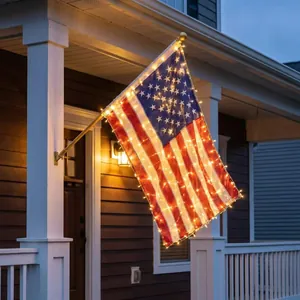 Illuminated USA American flag banner with warm LED lights mounted on a porch pole