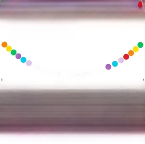 Detail view of 9.8ft colorful rainbow honeycomb garland, paper dot and triangle party banners