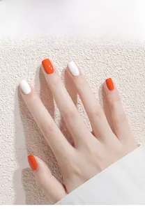 Detail showing glossy orange-red and pearly white water-based peelable nail polish