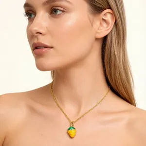 Detail view of model wearing a sweet yellow oil-drop strawberry pendant gold necklace chain