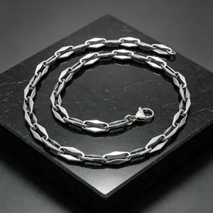 Detailed view of a polished stainless steel geometric link chain with lobster clasp