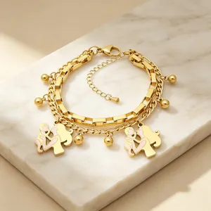 Gold double-layered stainless steel bracelet with mother-child charms on marble.
