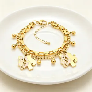 Detailed view of a gold double-layer stainless steel bracelet with mother-child charms