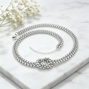 Detailed view of chunky double-layer stainless steel necklace with center knot design