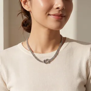 Close-up view of silver stainless steel double-layered knot necklace on female model