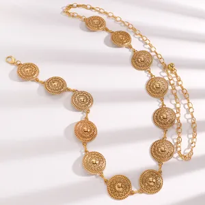 High-quality detail of elegant gold bohemian waist chain featuring sunburst medallions.