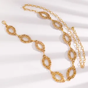 Detailed macro view of an elegant gold-toned metal waist chain belt with textured oval links.