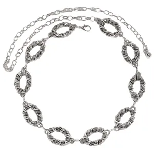 Detailed view of a silver ethnic style decorative metal chain belt for women's dresses
