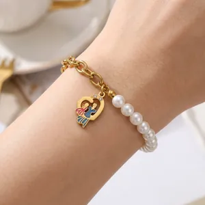 Macro detail of Mother's Day heart pendant bracelet with white pearls and gold chain