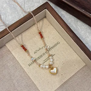 Exquisite detailed close-up of beaded necklace with pearls and gold-bordered heart pendant