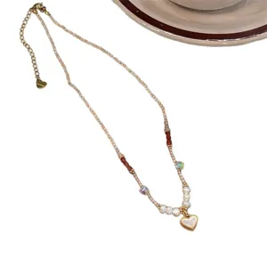 Elegant handmade beaded necklace with white shell heart pendant and pearls for women