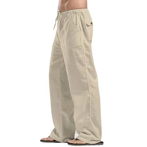 Side view of men's loose linen casual trousers in beige with drawstring waist and pockets