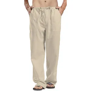 Detail view of comfortable men's beige loose fit linen trousers featuring a drawstring waist