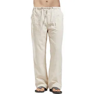 Detail of men's loose linen casual pants with drawstring waist and pockets in beige color