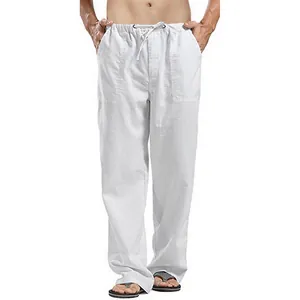 Close-up of men's loose white linen trousers with comfortable drawstring waist design