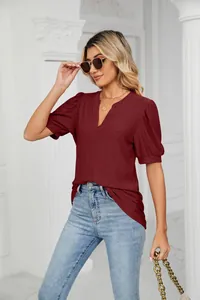 Elegant burgundy top featuring intricate hollow-out texture and stylish puff sleeves