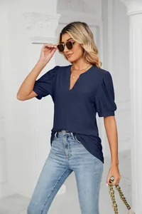 Casual navy blue V-neck top with intricate hollow-out pattern and stylish puff sleeves