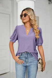 Elegant detail of purple V-neck eyelet blouse with stylish puff sleeves on a model