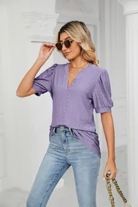 Elegant purple V-neck blouse featuring intricate eyelet hollow-out details and puff sleeves.