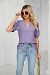 Detailed view of women's purple V-neck eyelet top with puff sleeves and casual fit