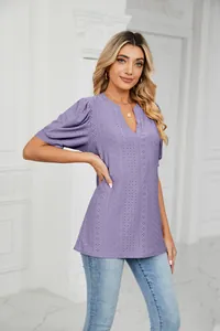 Elegant lavender V-neck top featuring intricate eyelet embroidery and puff sleeves