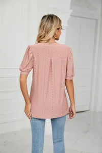 Close-up back view of elegant pink eyelet puff sleeve blouse with hollow-out pattern