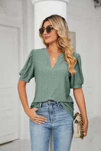 Elegant casual green V-neck blouse featuring hollow-out eyelet patterns and puff sleeves