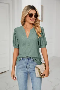 Close-up of a stylish summer green V-neck hollow-out puff sleeve loose casual t-shirt for women